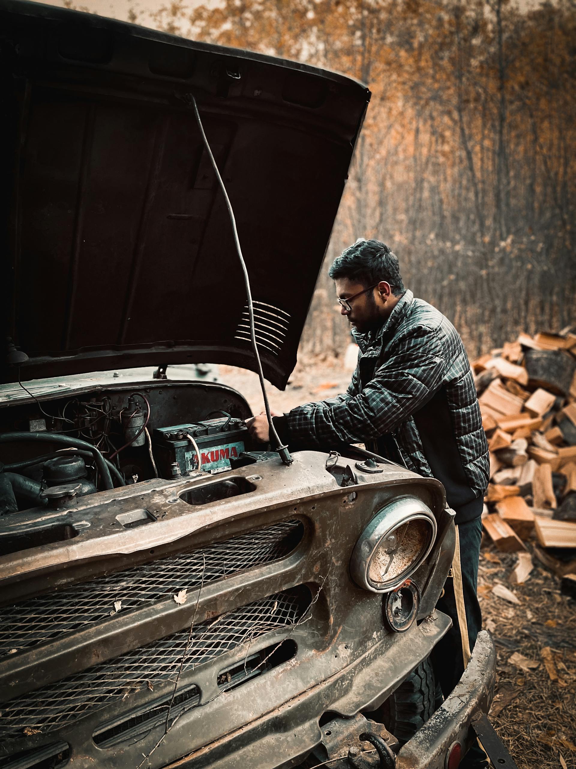 Mobile mechanic diagnosing auto electrical issue outdoors in Oklahoma City