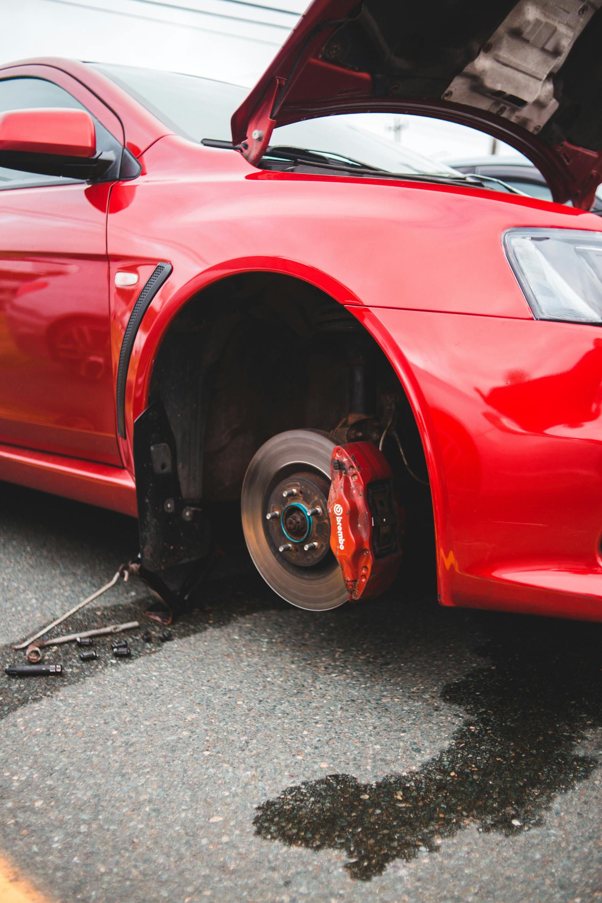 Mobile mechanic replacing suspension components on vehicle outdoors in Oklahoma City