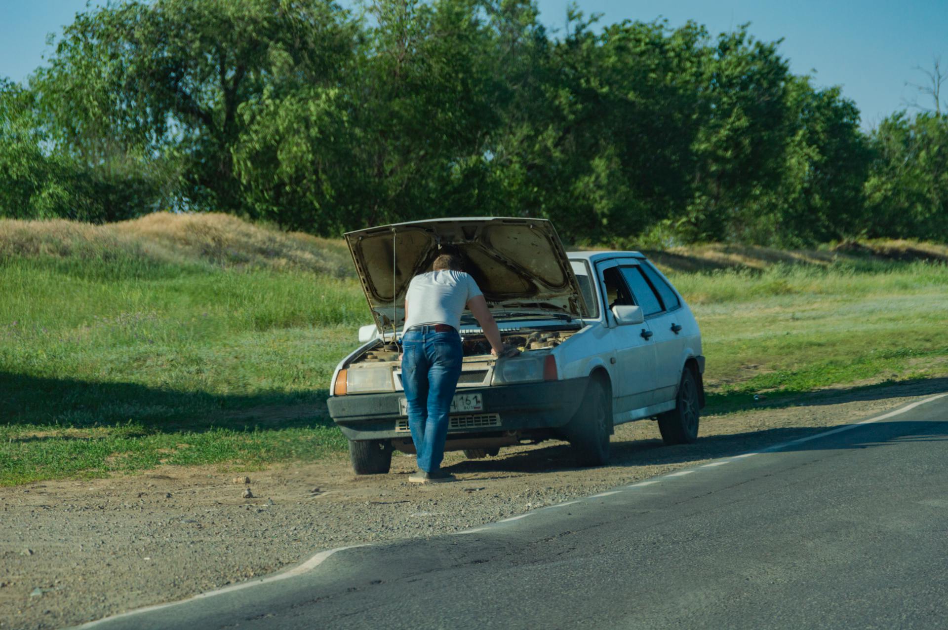 Car with hood up on roadside needing cooling system service in Oklahoma City