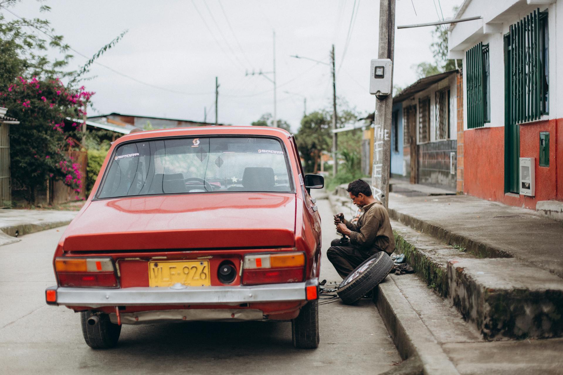 Mobile mechanic repairing flat tire on roadside in Oklahoma City